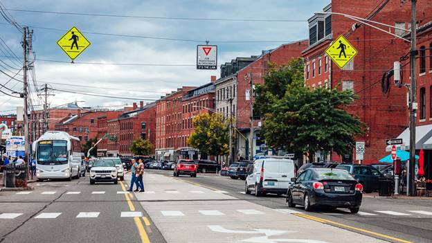 A street with cars and buildings
AI-generated content may be incorrect.